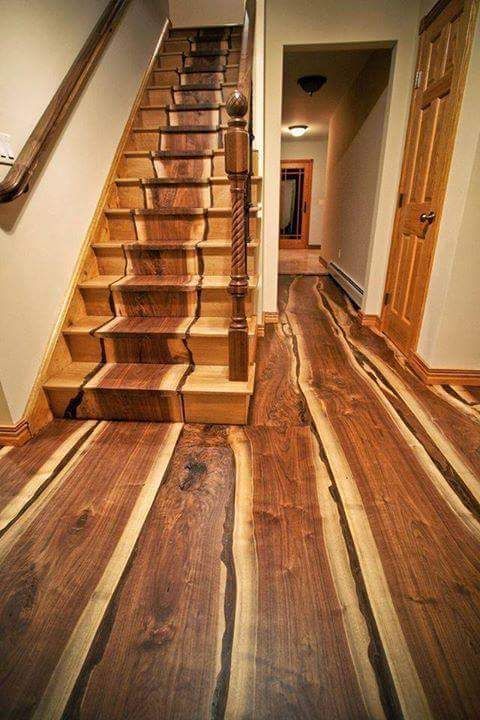 A wooden staircase with a wooden floor in a hallway.