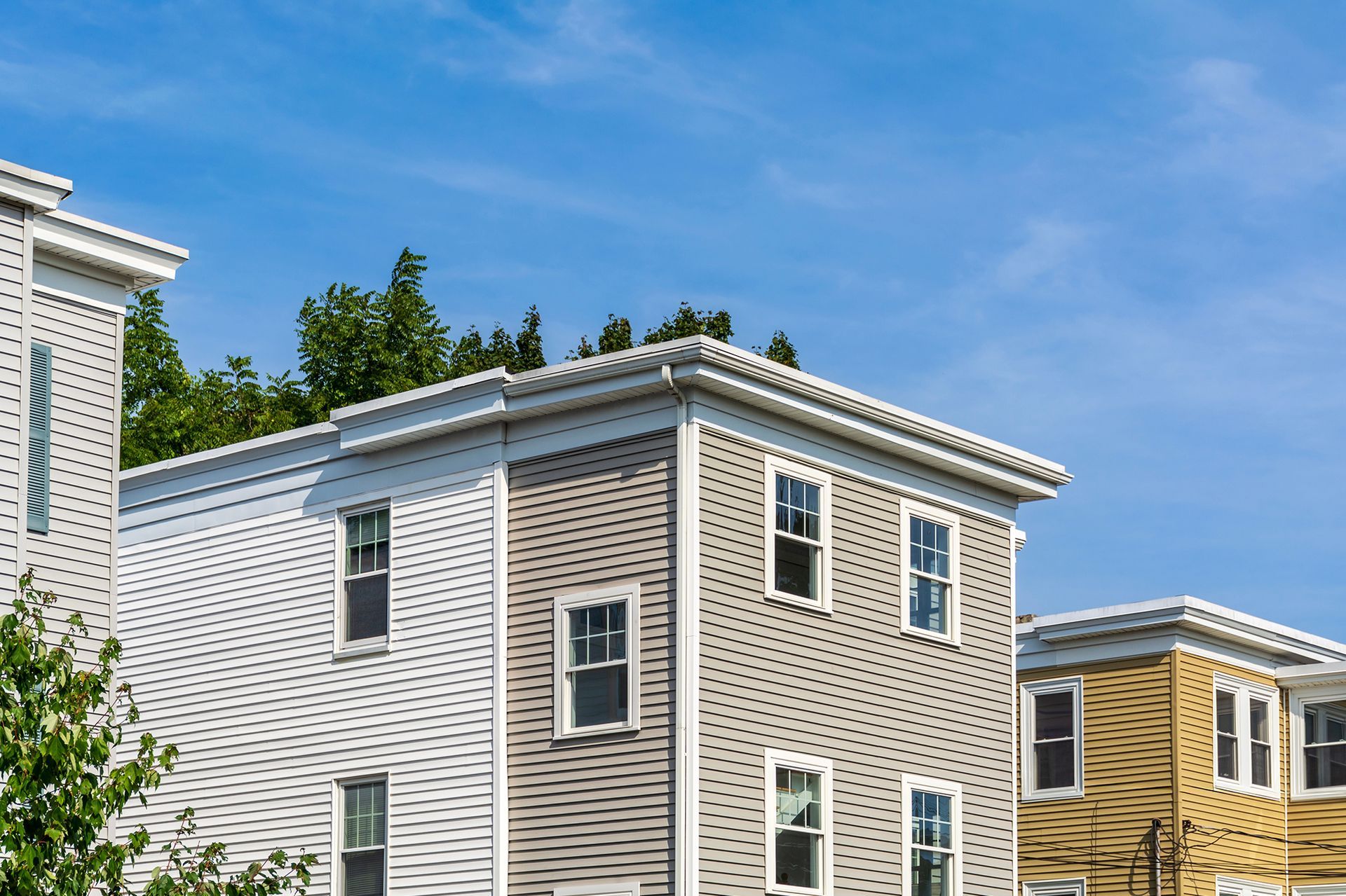 A row of houses with a blue sky in the background