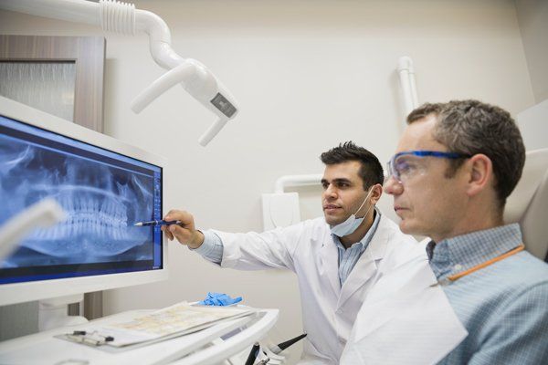 dentist showing patient a scan of his teeth
