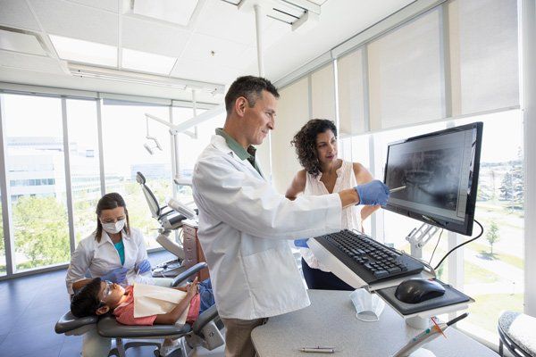 dentist looking at mouth xrays
