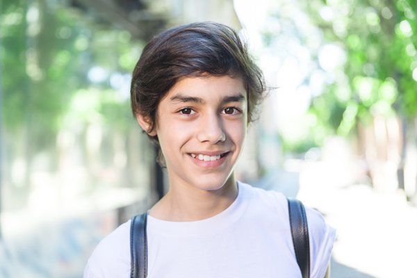 A young man smiling after receiving wisdom teeth removal in Campbelltown