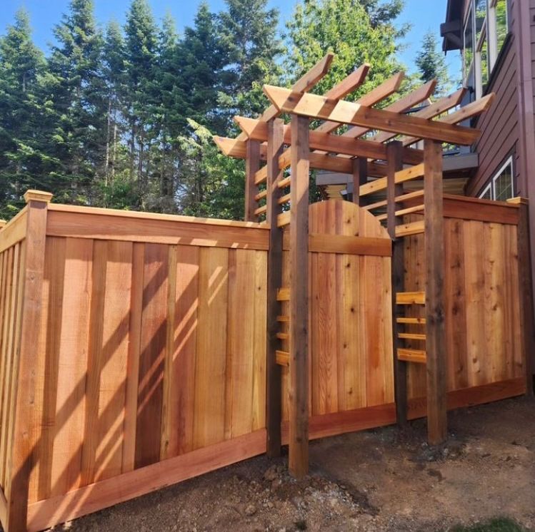 A wooden fence with a pergola attached to it