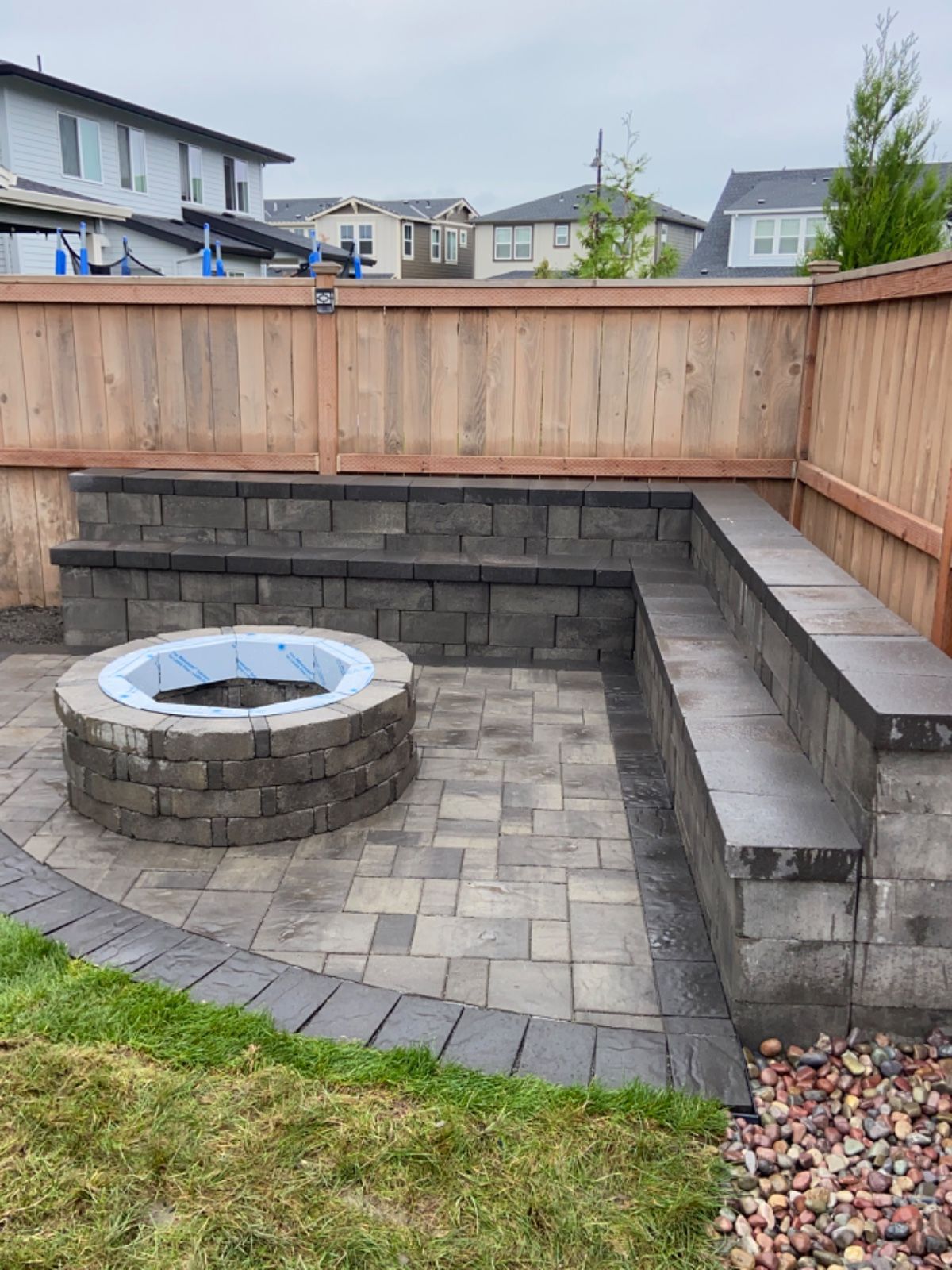 There is a fire pit in the middle of the patio.