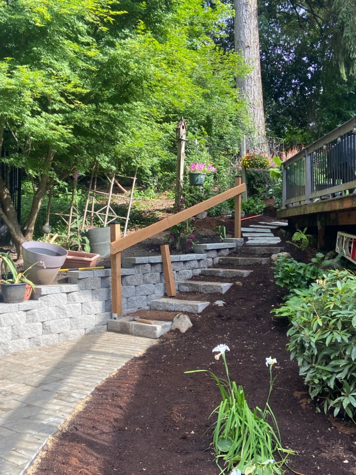 There are stairs leading up to a deck in the backyard.