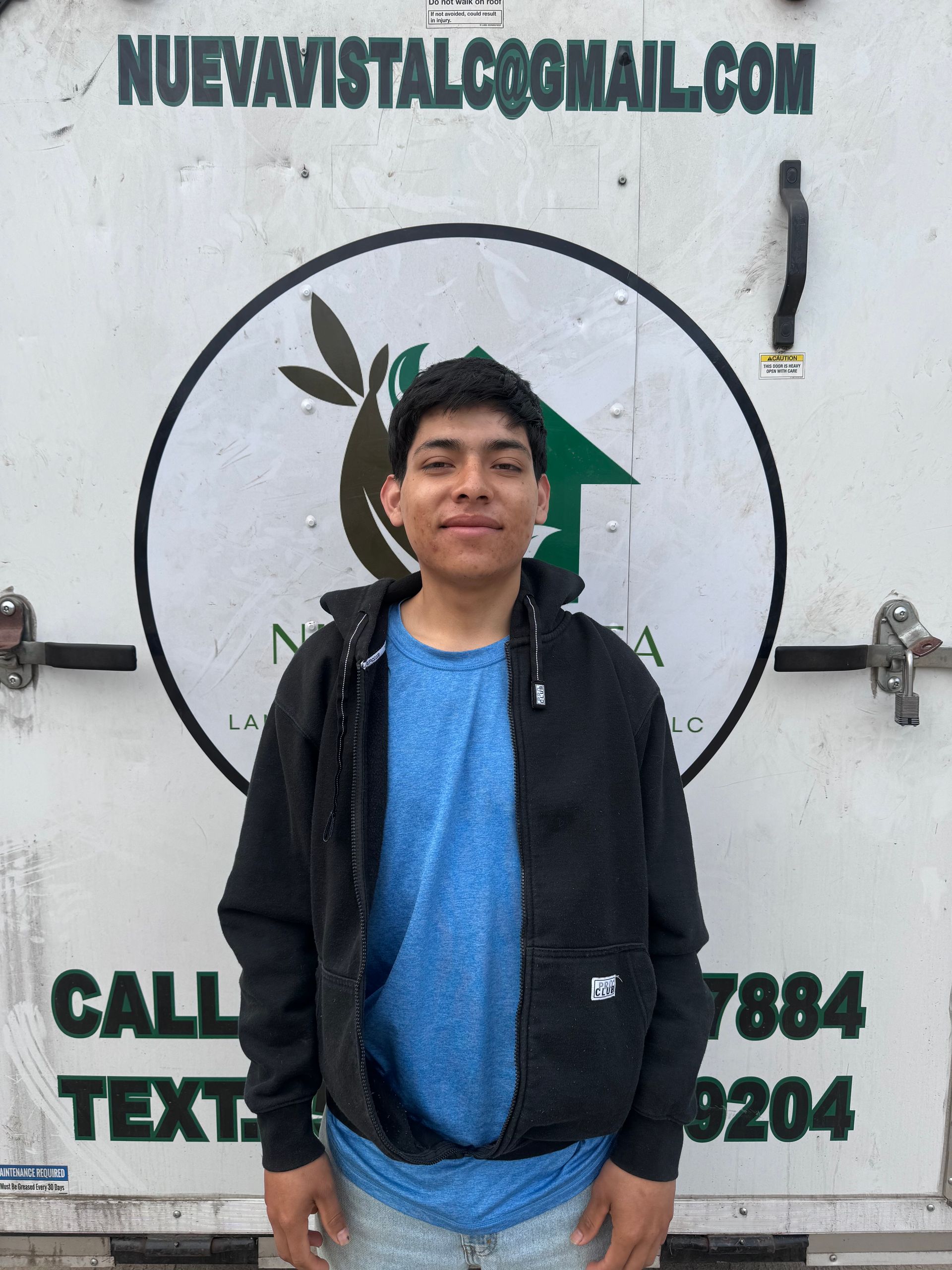 A man standing in front of a truck that says call text
