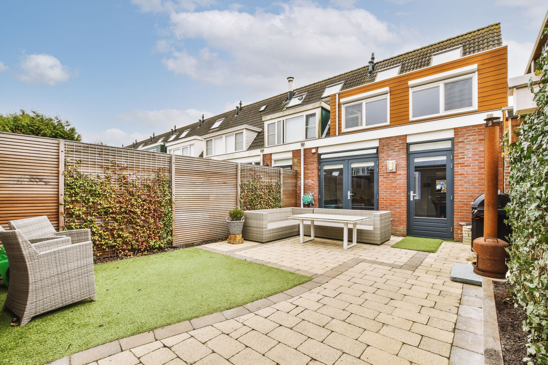 A brick house with a patio in front of it