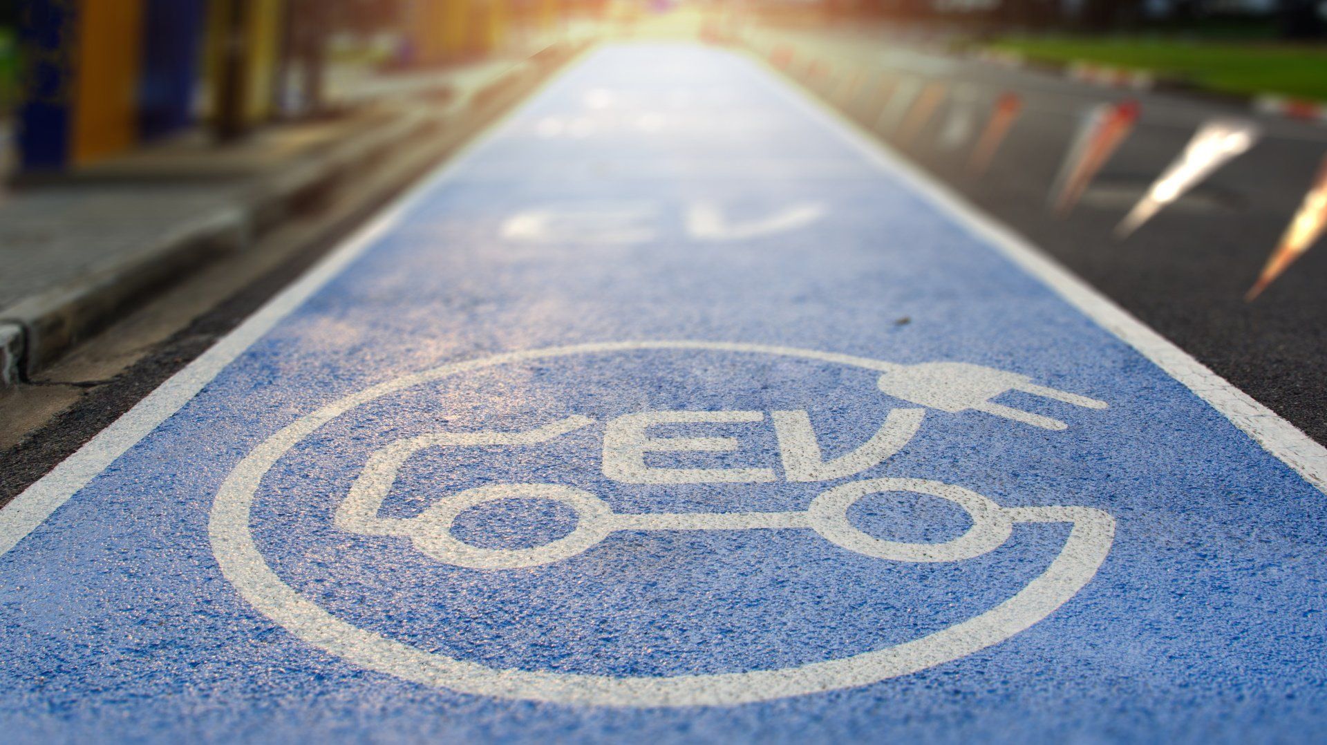 A blue and white road with a bicycle sign on it.