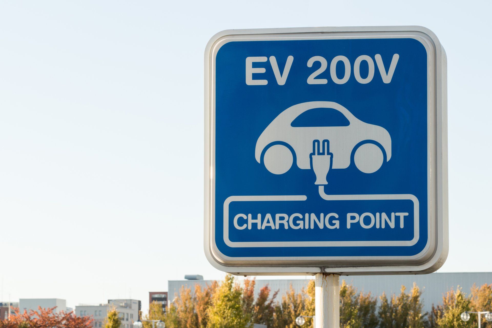 A blue sign that says ev 200v charging point