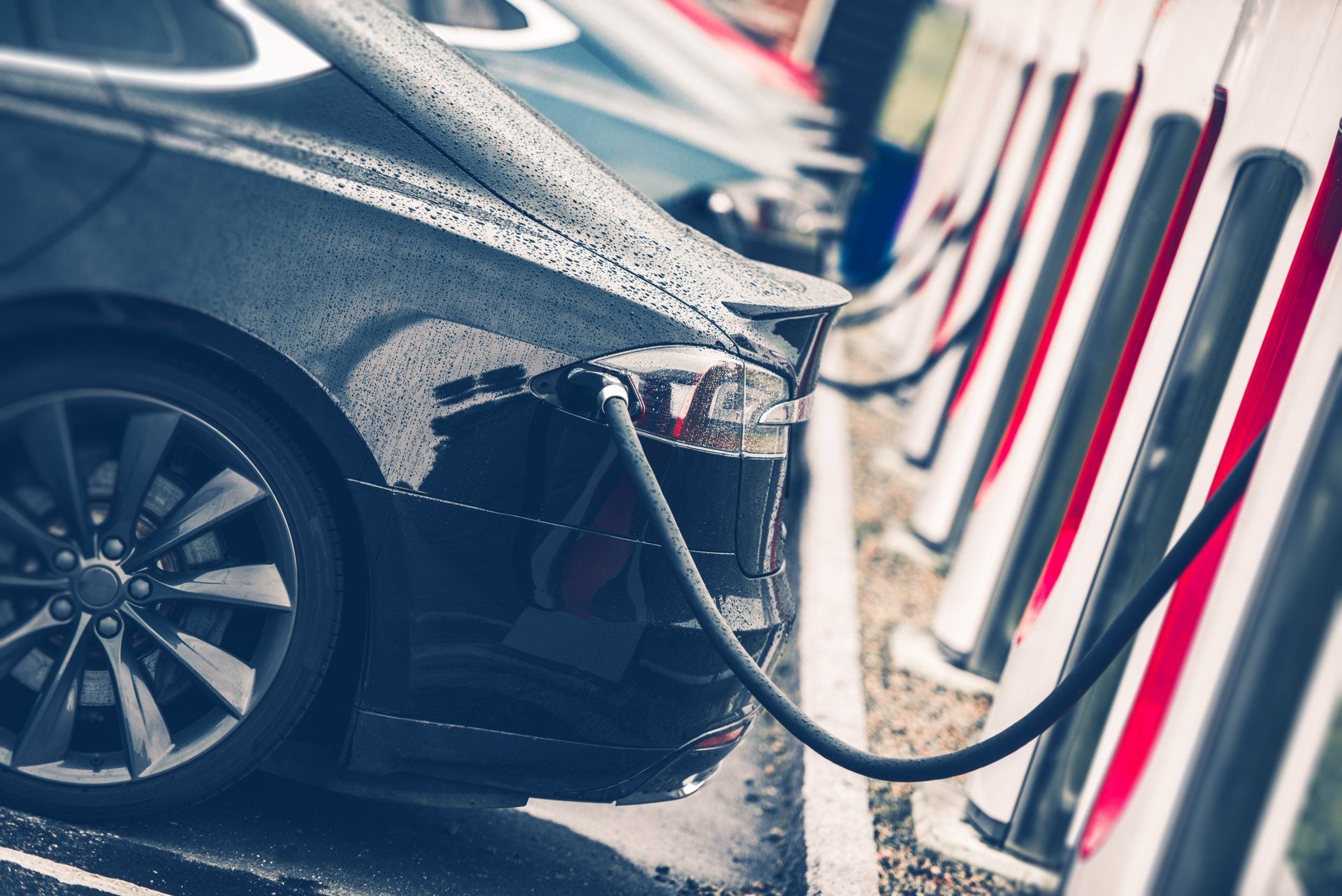 An electric car is being charged at a charging station.