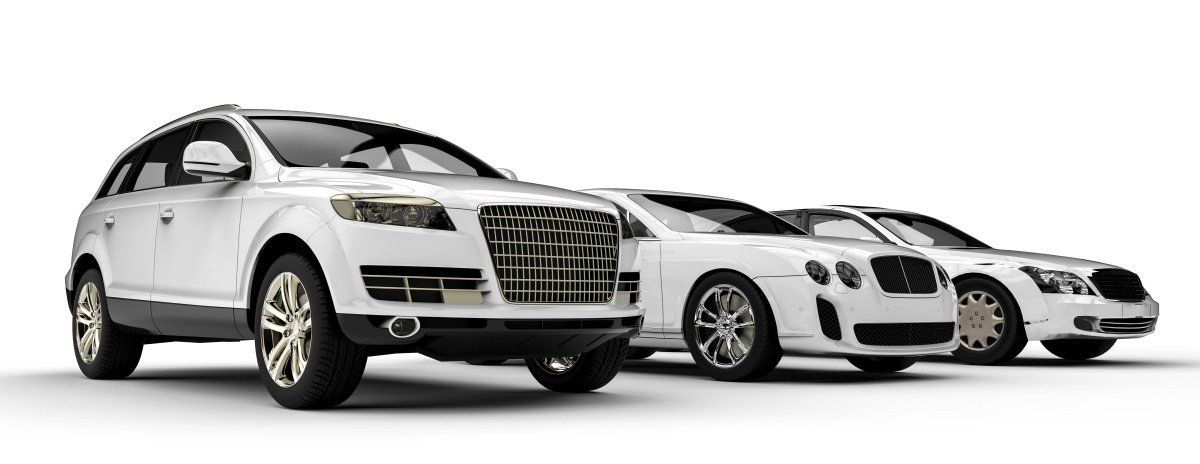 Three white cars are parked next to each other on a white background.