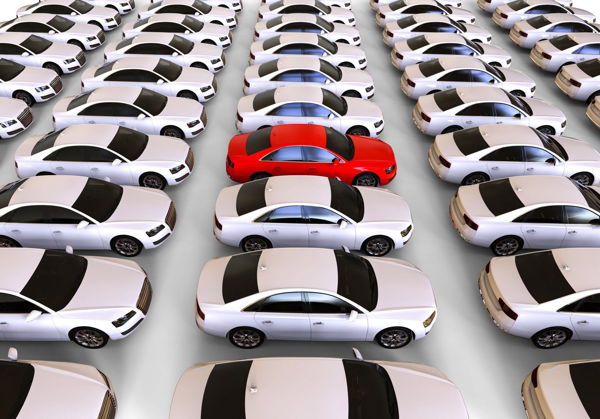 A red car is in the middle of a row of white cars