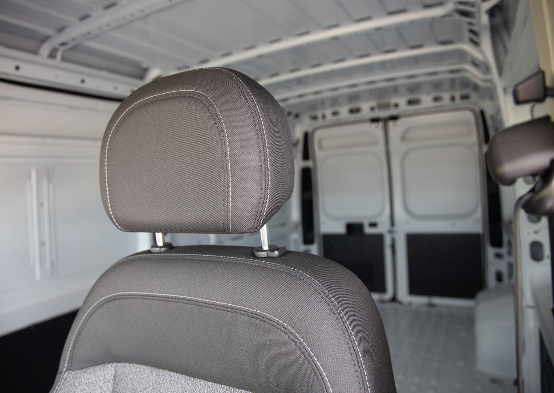 A close up of a headrest in the back of a van.