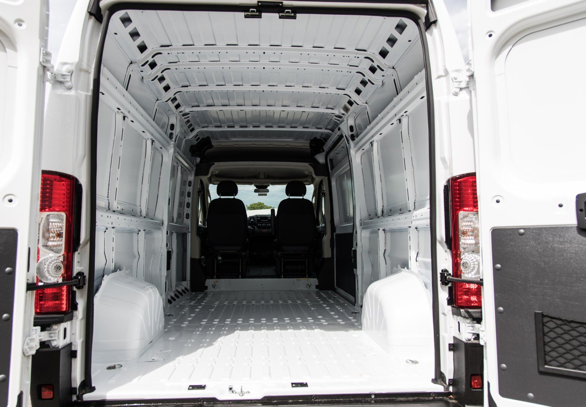 The inside of a white van with the door open