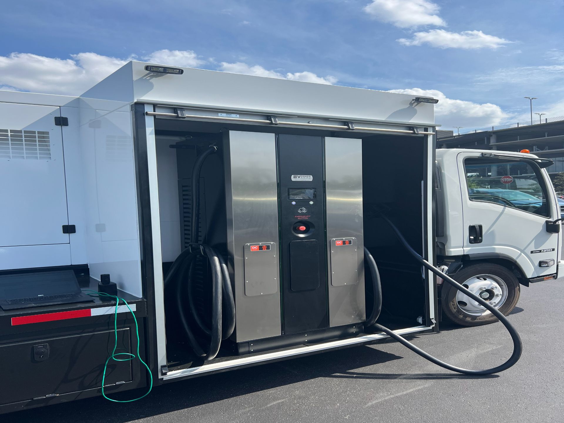 A truck is being fueled with a hose attached to it.