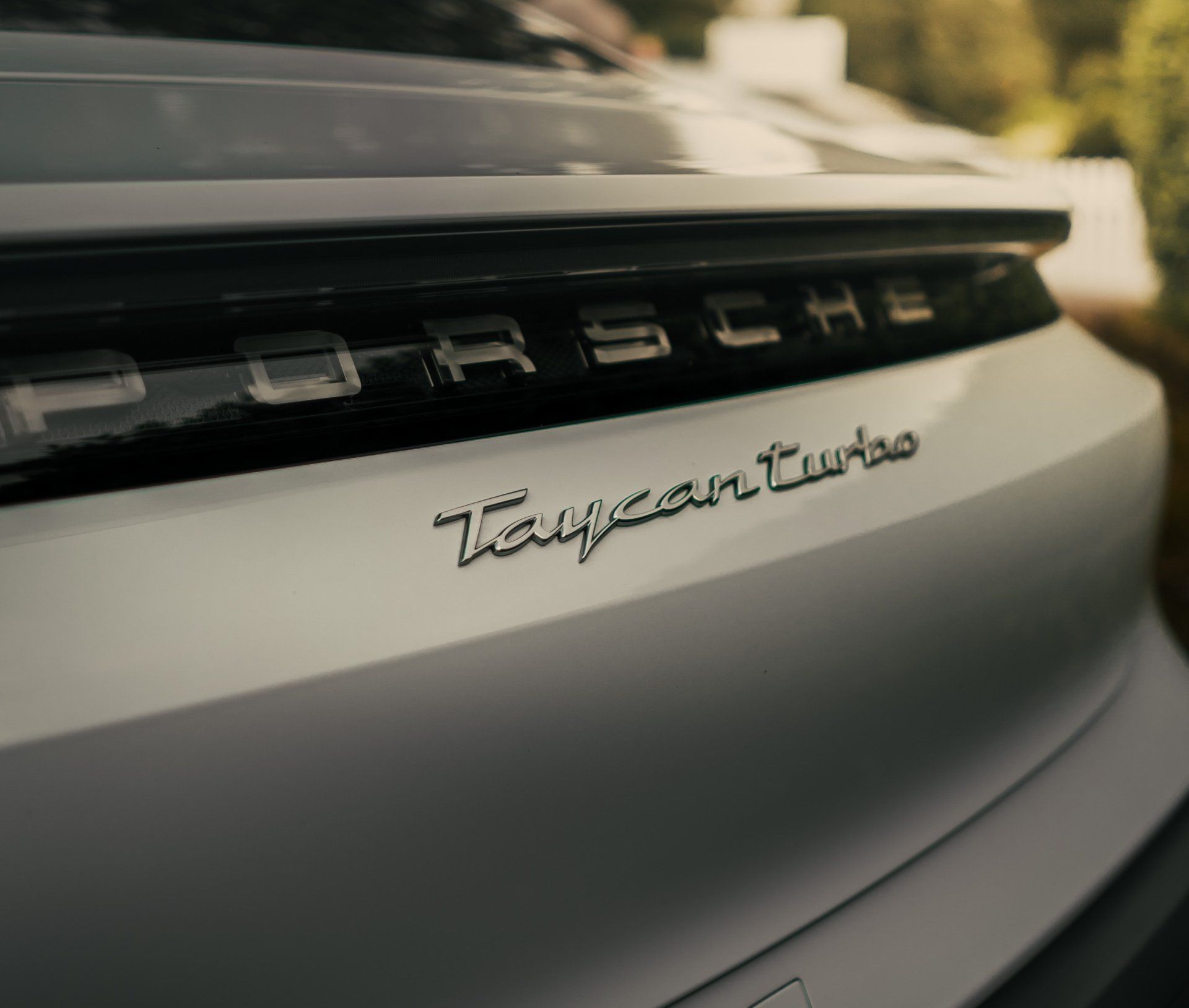 The back of a white porsche taycan turbo