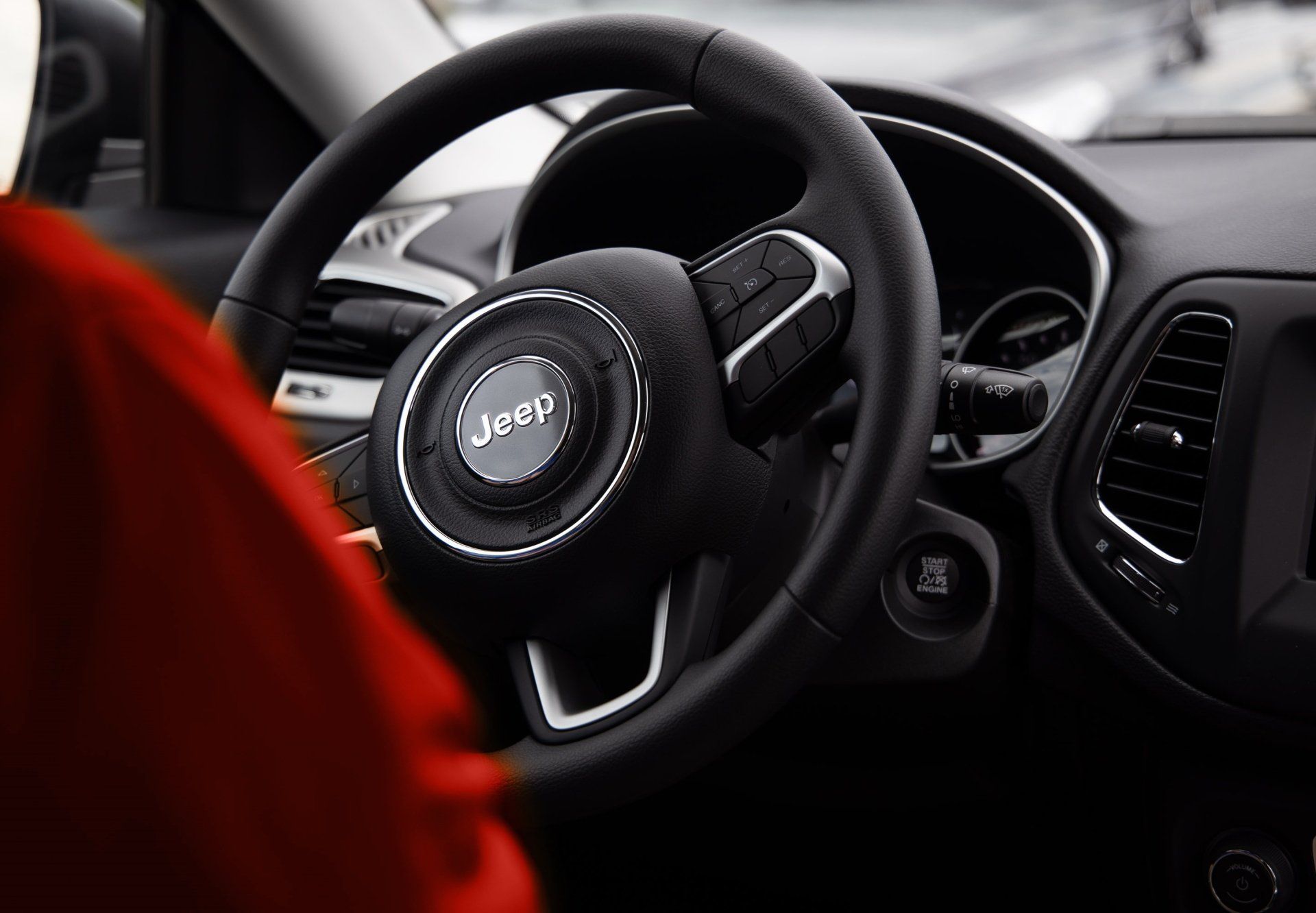 A close up of a steering wheel in a jeep.