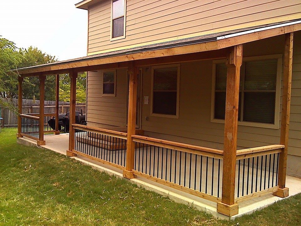 A wooden deck with a grill and a table on it.