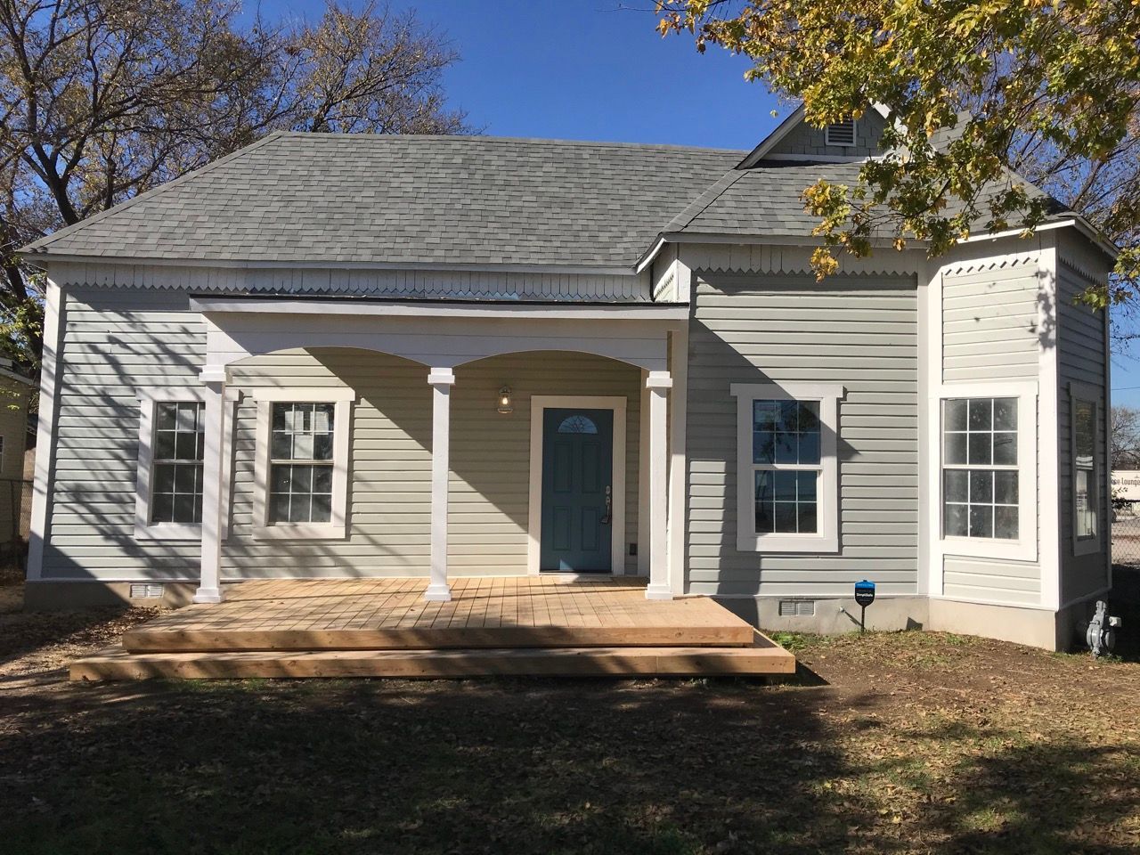 A wooden patio with a couch and a table made out of wooden pallets