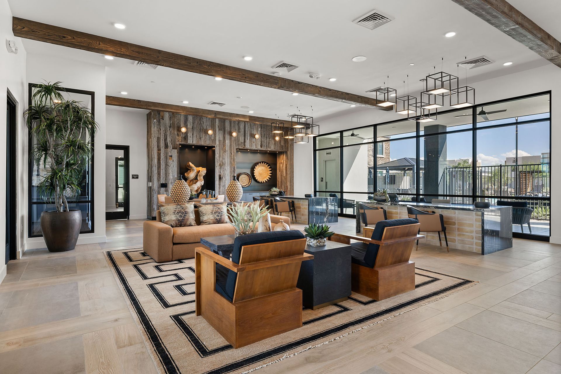 Lounge area with exposed beams, large windows, seating, and decorative elements at Marq Bronco Butte, offers brand-new apartments for rent in North Phoenix, AZ.