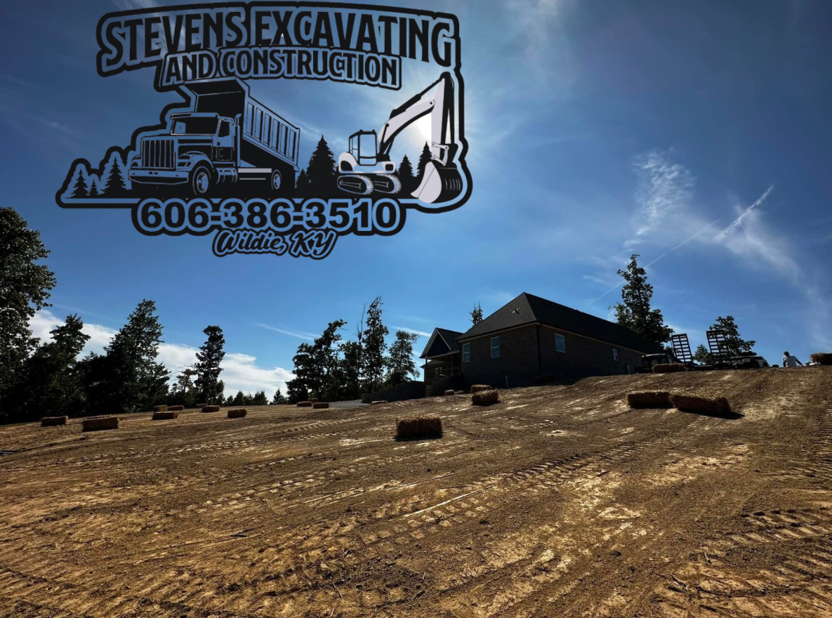 Stevens Excavating logo over a construction site with a house, blue sky, and hay bales.