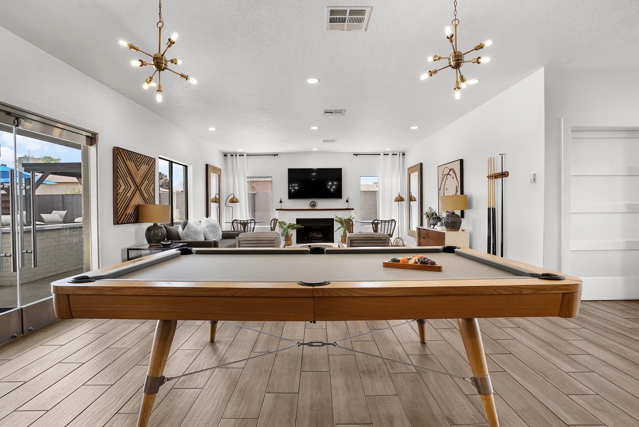 Indoor community gameroom with a pool table, seating, and a fireplace.
