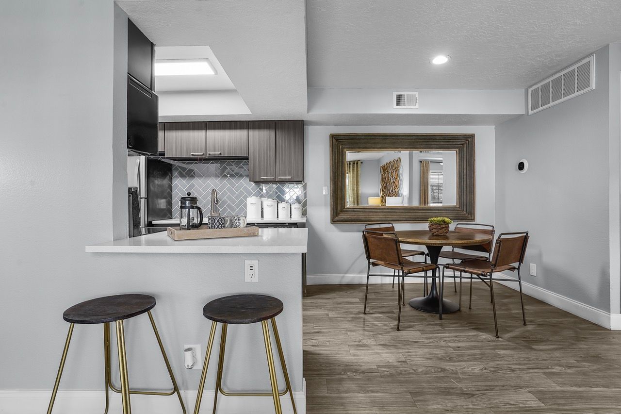 Open-concept kitchen and dining area in a modern apartment.