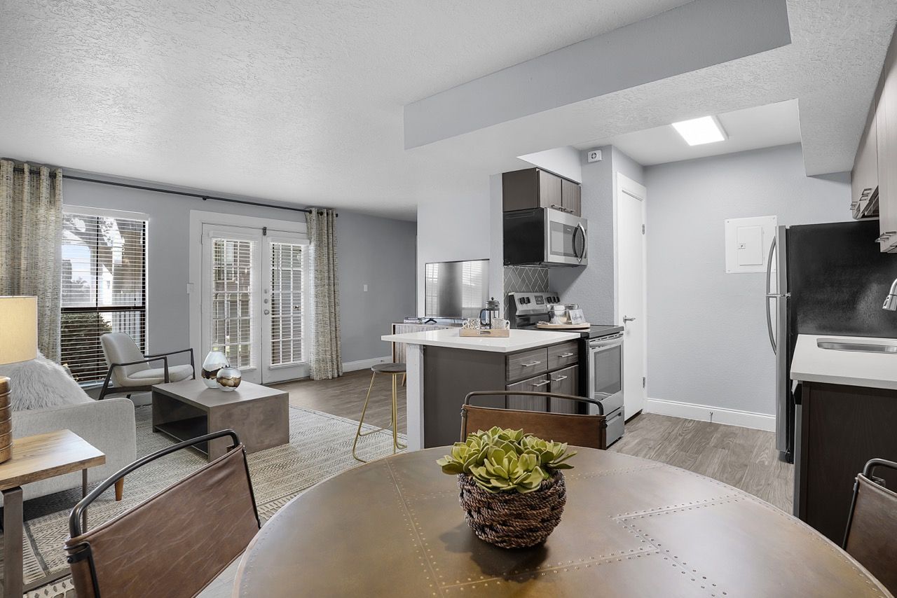 Telegraph Hill  apartment living area with a modern kitchen, dining table, and glass doors.