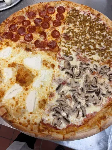 A large pizza cut into four sections: pepperoni, sausage, cheese, and mushrooms.