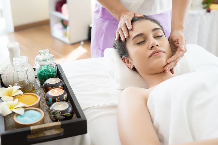 A woman is getting a head massage at a spa.