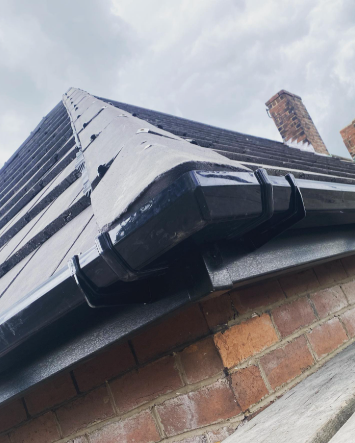 A picture of a roof gutter in black PVC