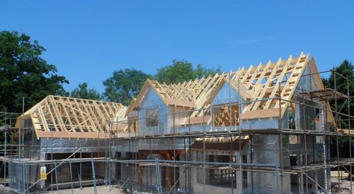 a large house is being built with scaffolding around it