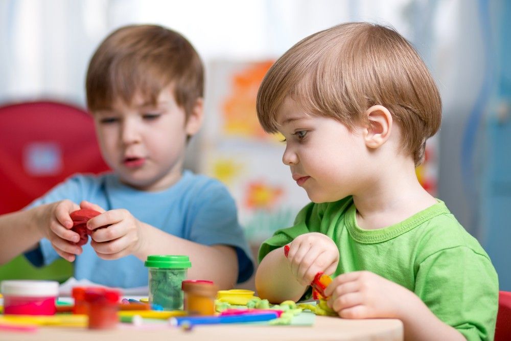Two Young Boys Are Playing With Play Dough at a Table — Woodlands Child Care Centre in East Albury, NSW