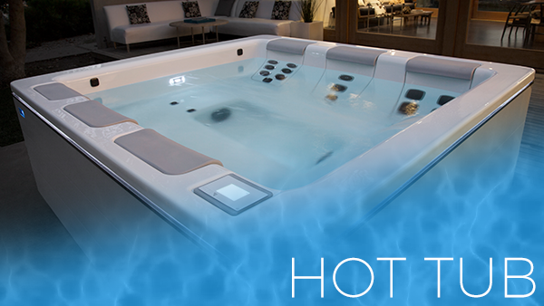 White outdoor hot tub with blue water and jets, labeled “HOT TUB” in the corner