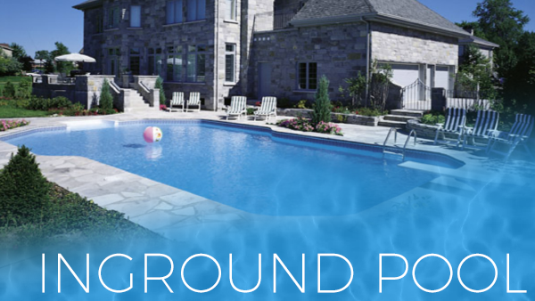 Blue backyard inground pool beside a stone house with lounge chairs and a floating ball