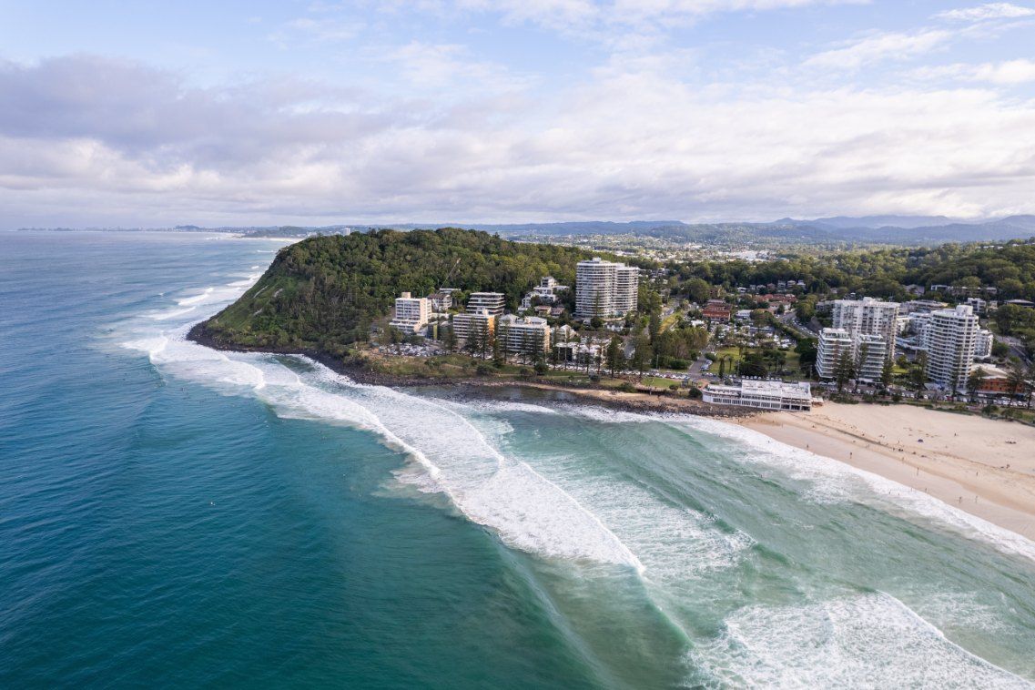 An Aerial View of a Beach With Waves Crashing on the Shore — Tweed Coast Pool Care in Burleigh Heads, QLD