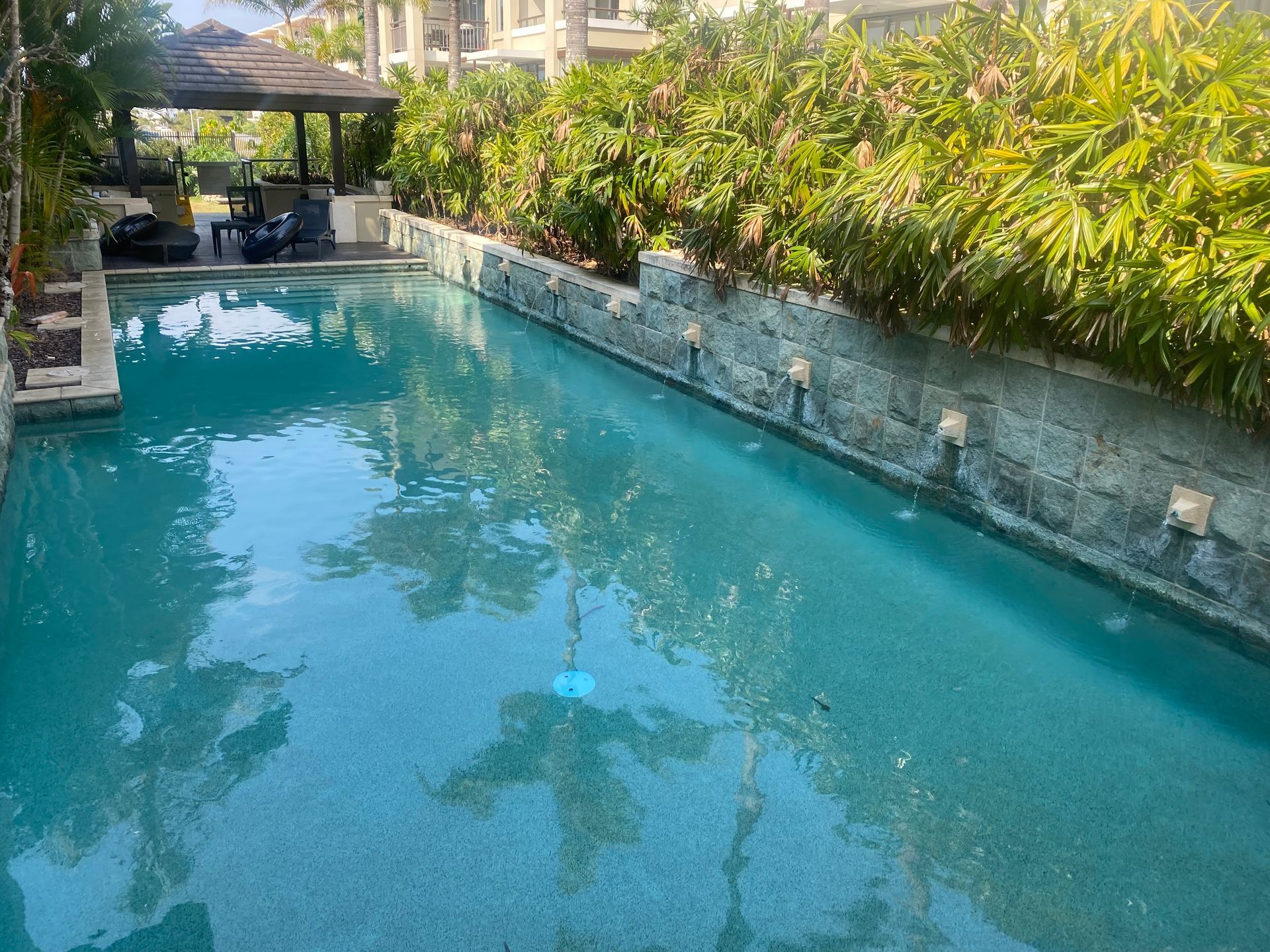 A Blue Tank is Sitting on Top of a Machine With Pipes — Tweed Coast Pool Care in Currumbin Valley, QLD