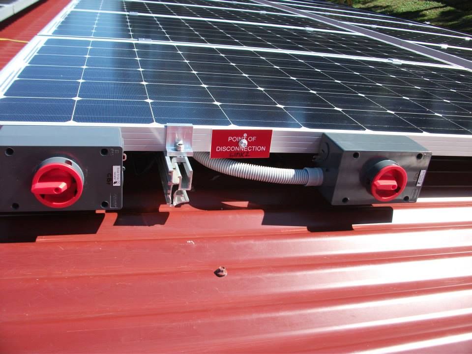 A Row Of Solar Panels On Top Of A Red Roof — CJ Electrical & Solar In Maitland, NSW