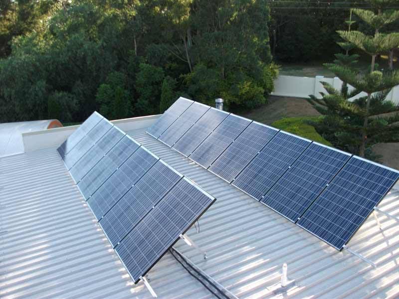 An Aerial View Of A Building With A Lot Of Solar Panels On The Roof — CJ Electrical & Solar In Somersby, NSW