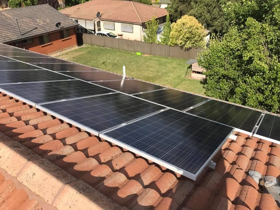 A Row Of Solar Panels On The Roof Of A House — CJ Electrical & Solar In Fern Bay, NSW