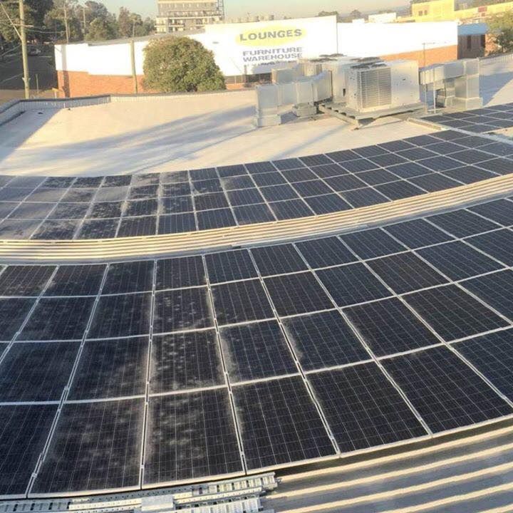 A Bunch Of Solar Panels On A Roof — CJ Electrical & Solar In Budgewoi, NSW