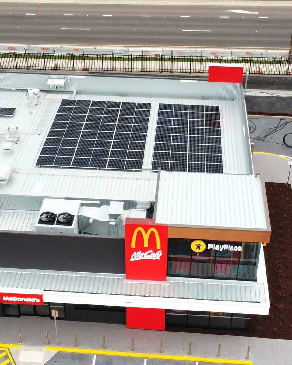 An Aerial View Of A Mcdonald 's With Solar Panels On The Roof — CJ Electrical & Solar In Morisset, NSW