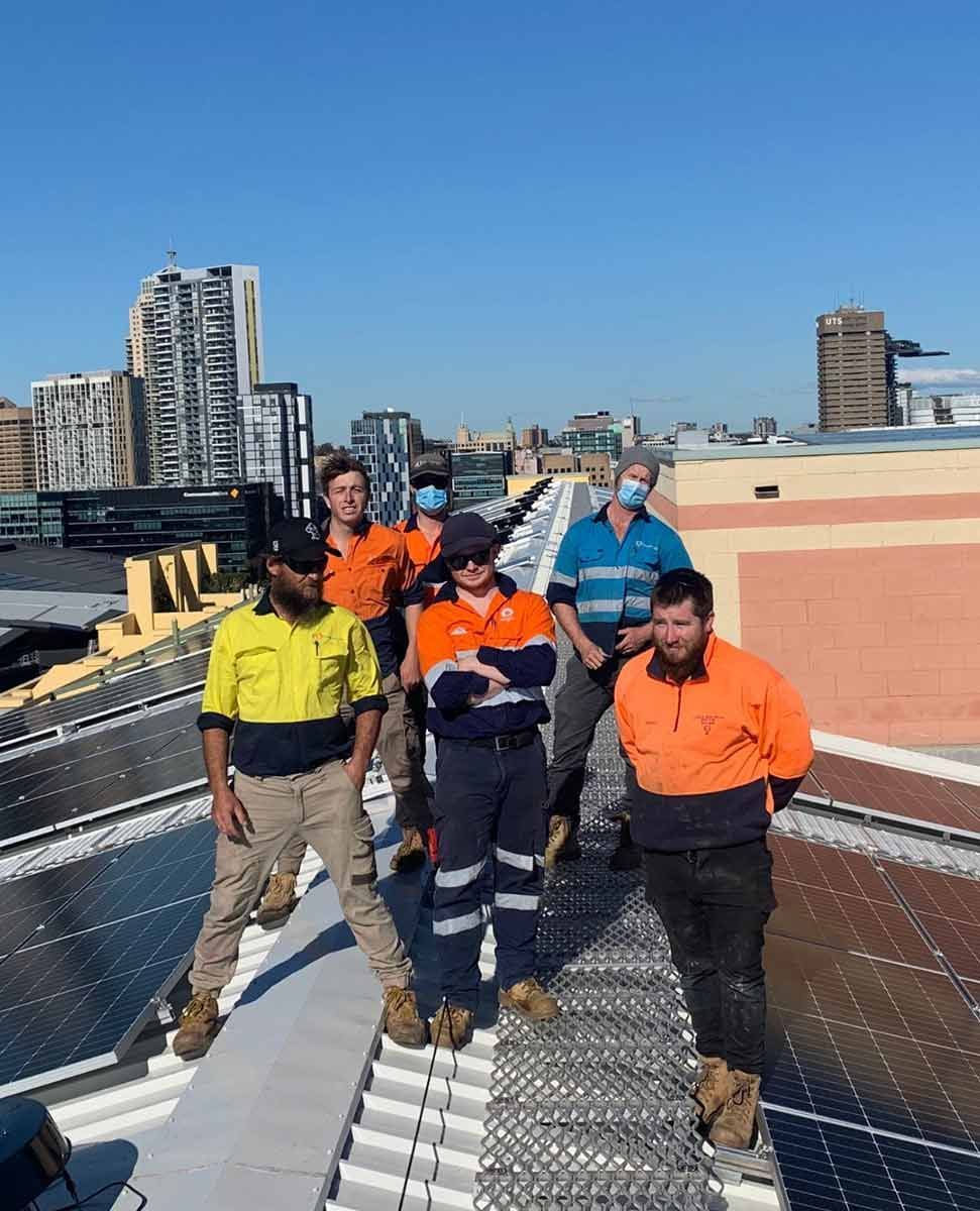 A Group Of Trucks Are Parked In Front Of A Building — CJ Electrical & Solar In Cardiff, NSW