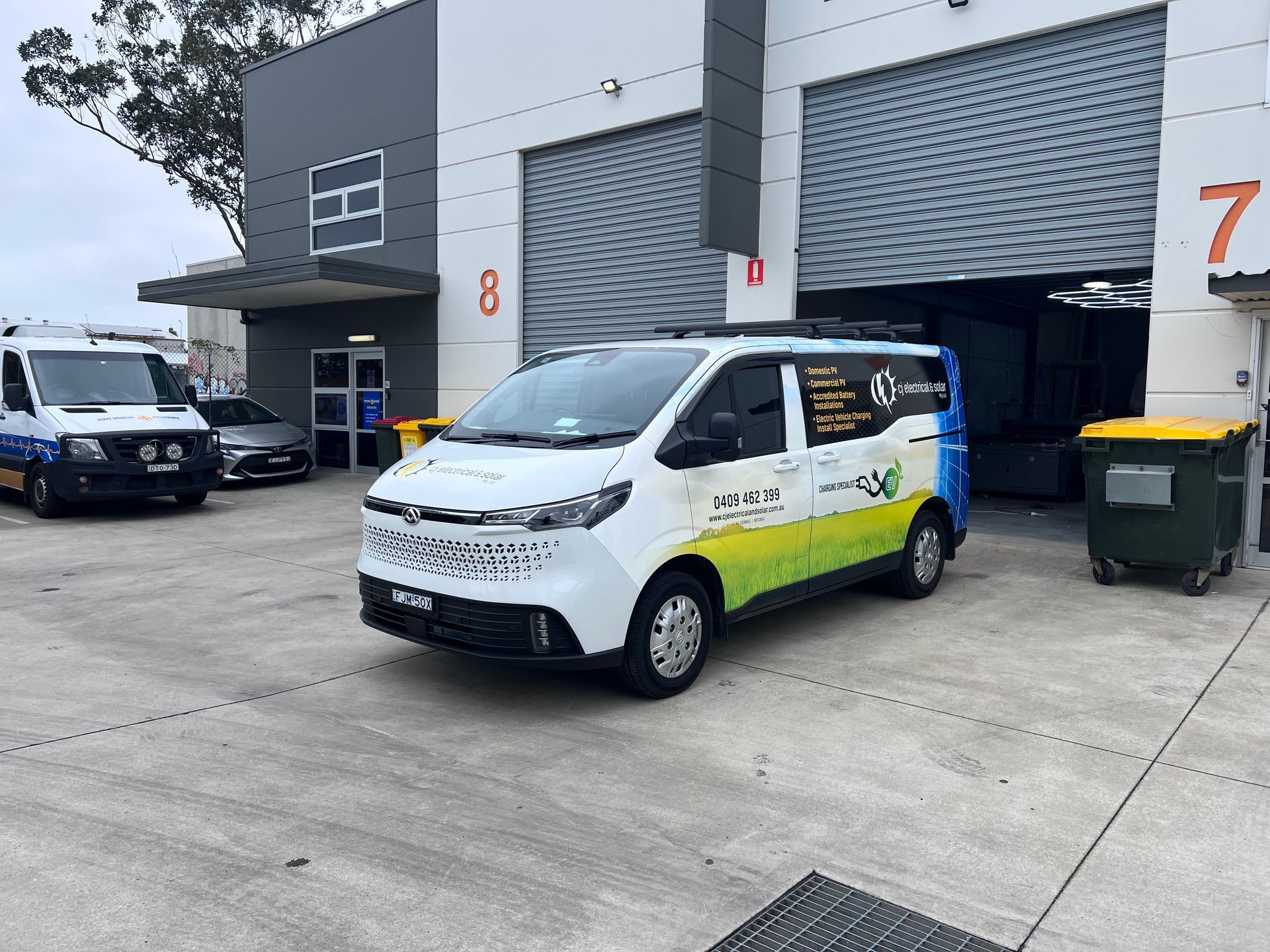 A Van With A Ladder On Top Of It Is Parked In Front Of A House — CJ Electrical & Solar In Cardiff, NSW