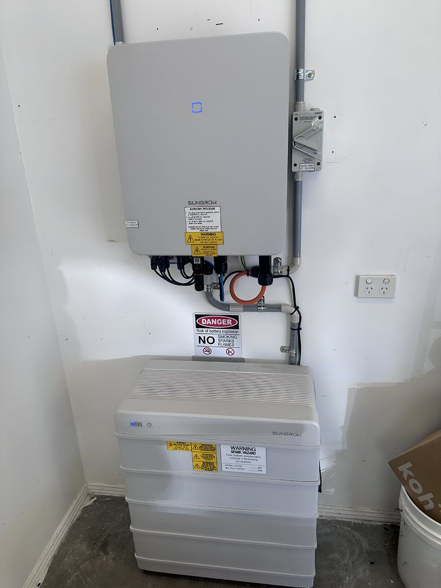 A Gray Box Is Sitting On Top Of A White Box In A Room — CJ Electrical & Solar In Thornton, NSW