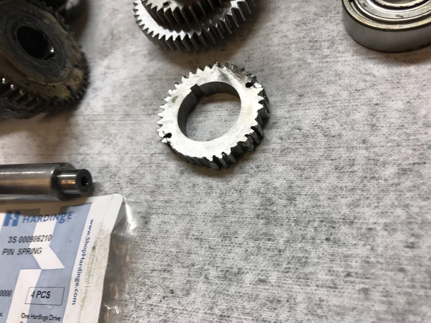 A bag of bearings is next to some gears