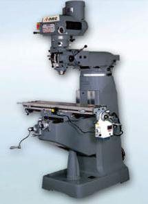 A gray milling machine is sitting on a blue surface.