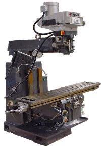 A machine is sitting on top of a table on a white background.