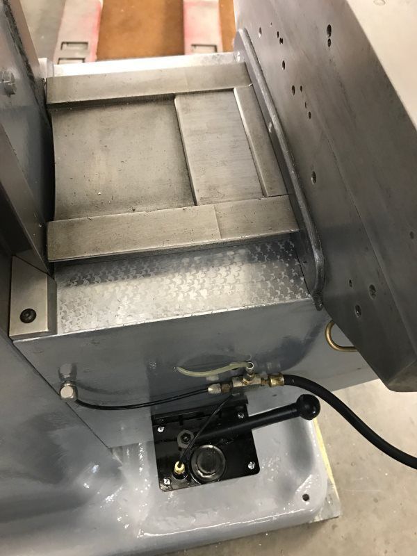 A close up of a machine with a hose attached to it