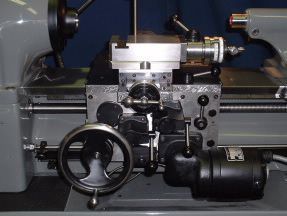 A close up of a lathe with a blue background