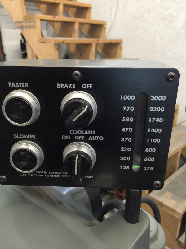 A control panel with buttons for faster brake off and coolant on off auto